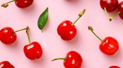 Cherries on a pink surface