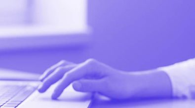 A woman typing on a laptop