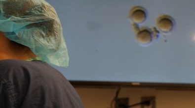 A Lab technician looking through microscopes
