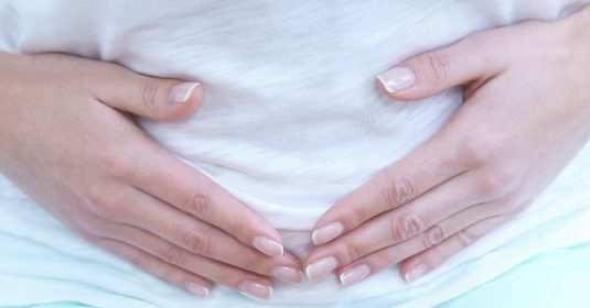 A woman holding her stomach