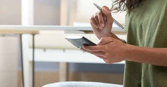 A woman using a calculator