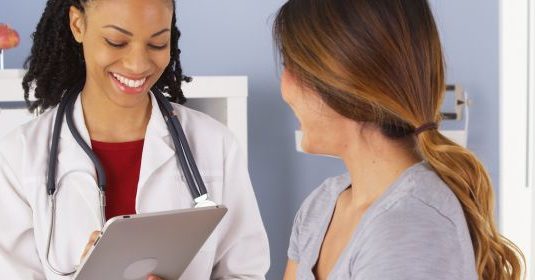 A woman speaking with her doctor