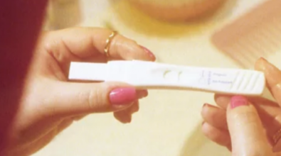 A woman reviewing a pregnancy test