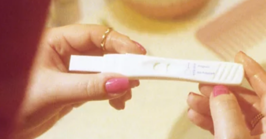 A woman reviewing a pregnancy test