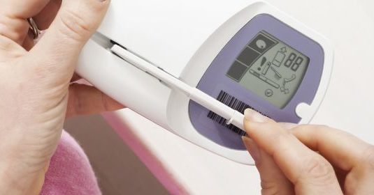 A woman looking at a meter
