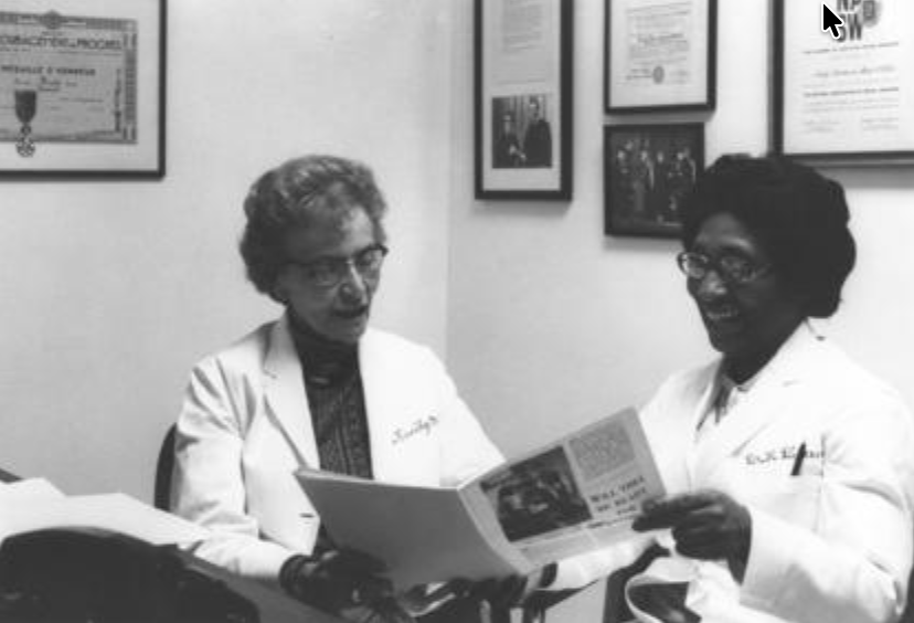 r. Helen O. Dickens and Dr. Emily Mudd sitting in a white office and reviewing a medical journal