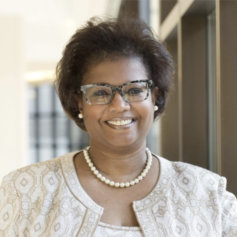 A professional headshot of Dr. Erica E. Marsh of the Division of Reproductive Endocrinology at the University of Michigan wearing a patterned blazer in a brightly lit office setting